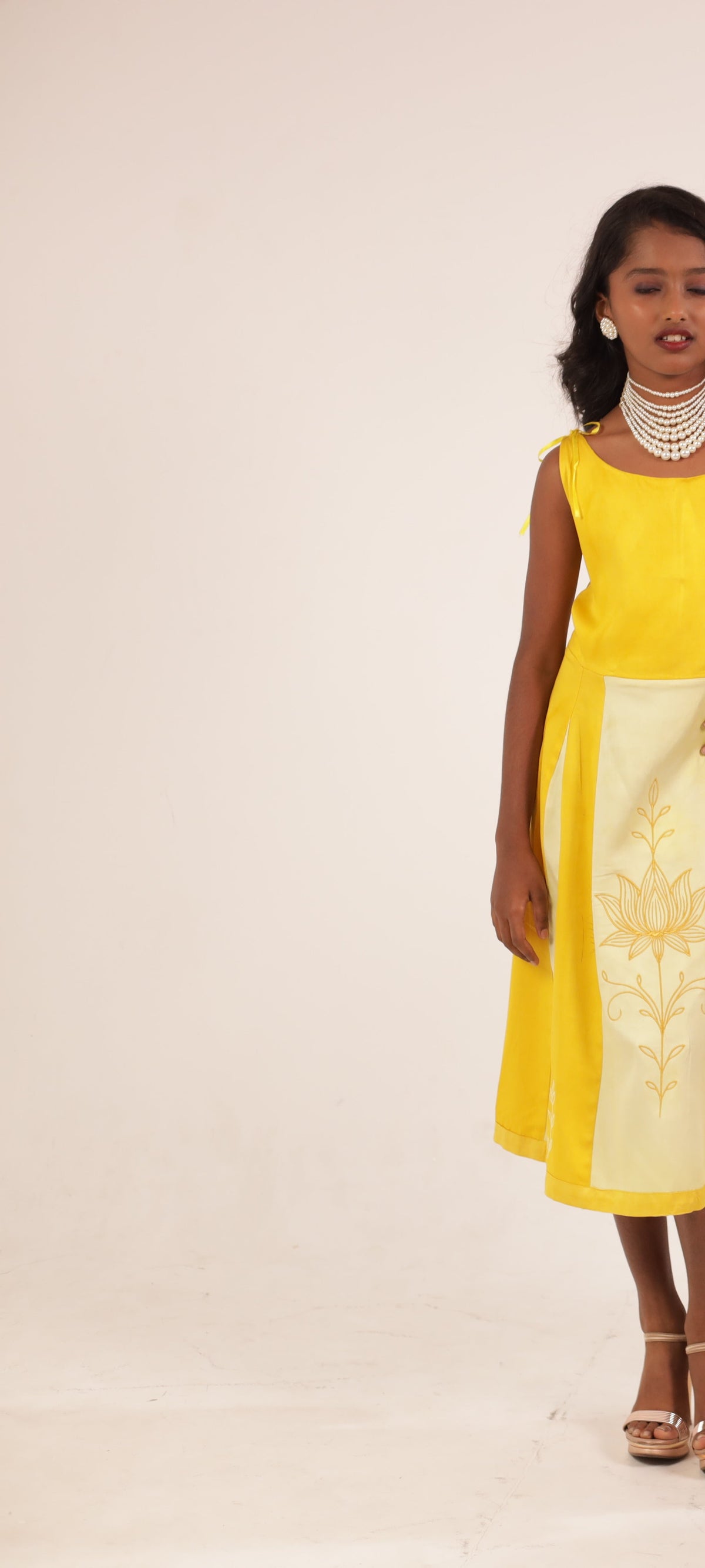 The Yellow Golden Blossom Frock by Zouhi, full length on a cream ground, gold lotus embroidery on the panel