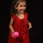 Primrose · Edition Two in movement — the loose A-line cut and ruffled hem of the scarlet eucalyptus frock