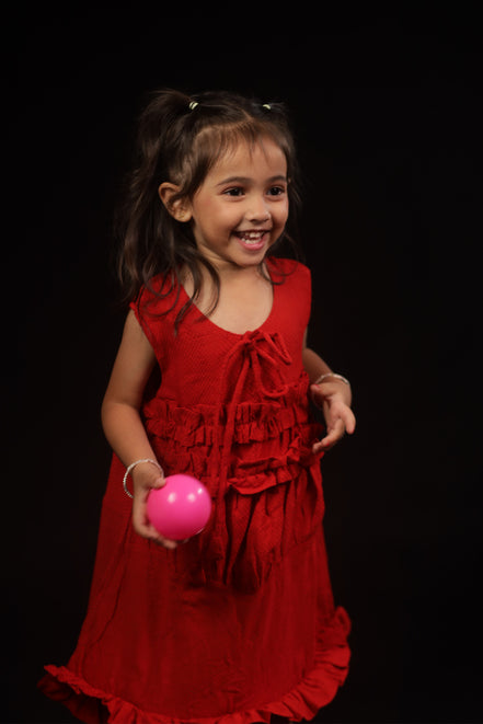 Primrose · Edition Two in movement — the loose A-line cut and ruffled hem of the scarlet eucalyptus frock