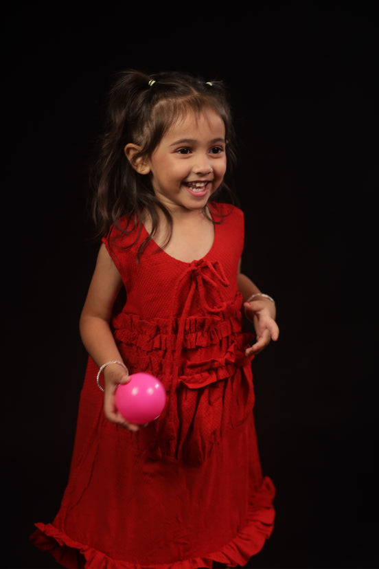 Primrose · Edition Two in movement — the loose A-line cut and ruffled hem of the scarlet eucalyptus frock