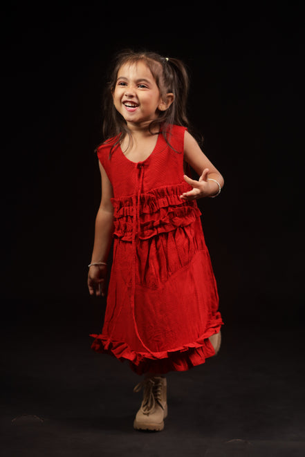 Close view of the gathered ruffle tiers and self-tie neck cord on Primrose, Zouhi Edition Two