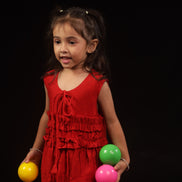Full front view of Primrose · Edition Two, a sleeveless scarlet kids frock in plant-based eucalyptus fibre, sizes 1 to 12 years