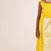 The Yellow Golden Blossom Frock by Zouhi, full length on a cream ground, gold lotus embroidery on the panel