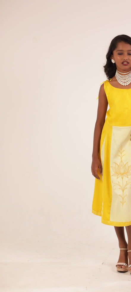 The Yellow Golden Blossom Frock by Zouhi, full length on a cream ground, gold lotus embroidery on the panel